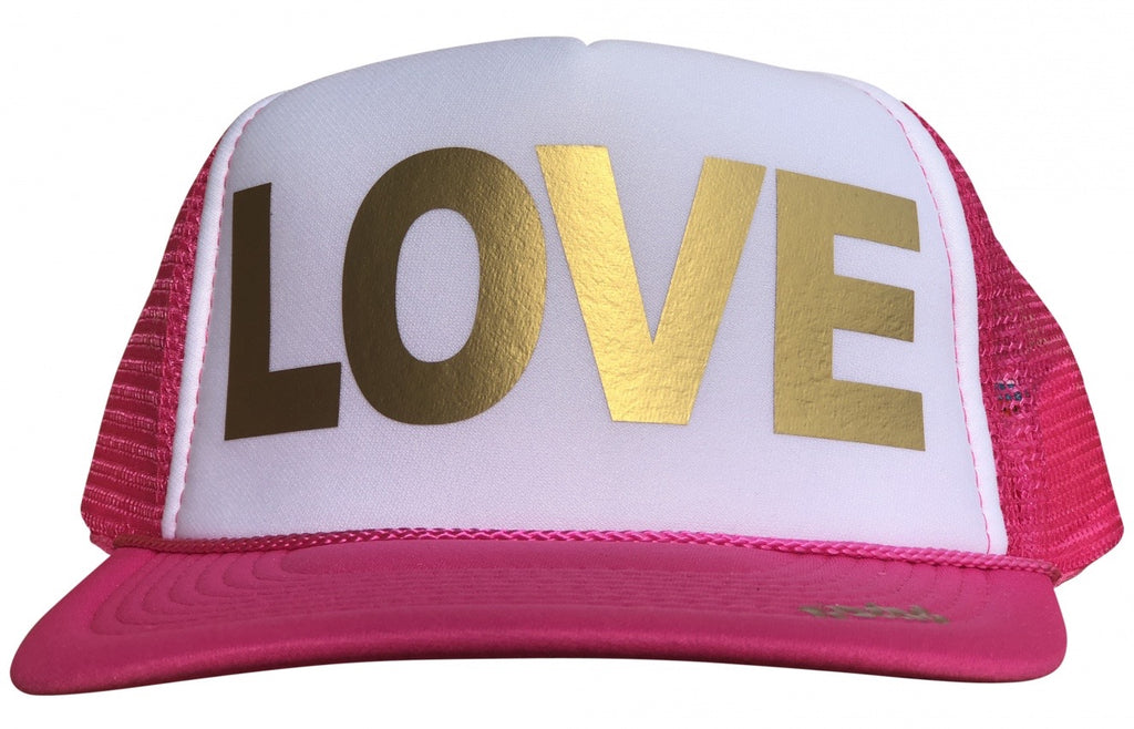 LOVE in gold ink on the front panel of a classic mesh pink-white trucker cap with an adjustable snapback