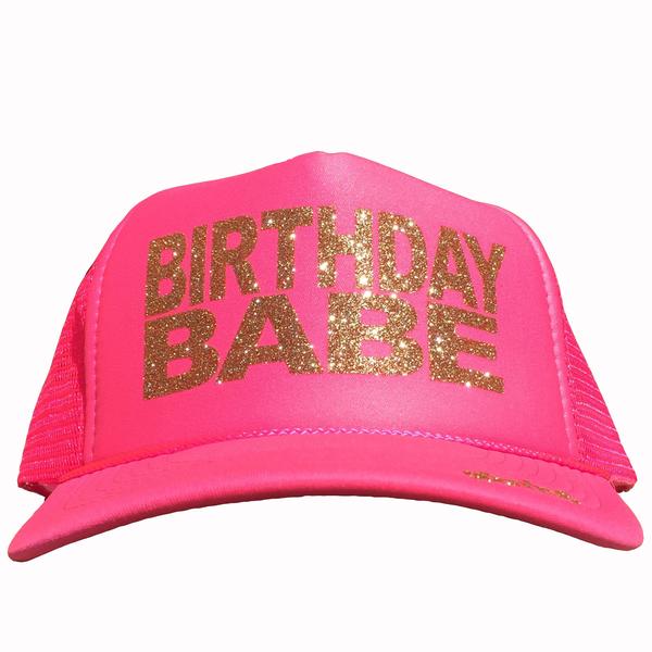 Birthday Babe in glitter gold ink on the front panel of a  pink trucker cap with an adjustable snapback