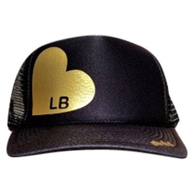 Heart with LB in gold ink on the front panel of a black mesh trucker cap with an adjustable snapback