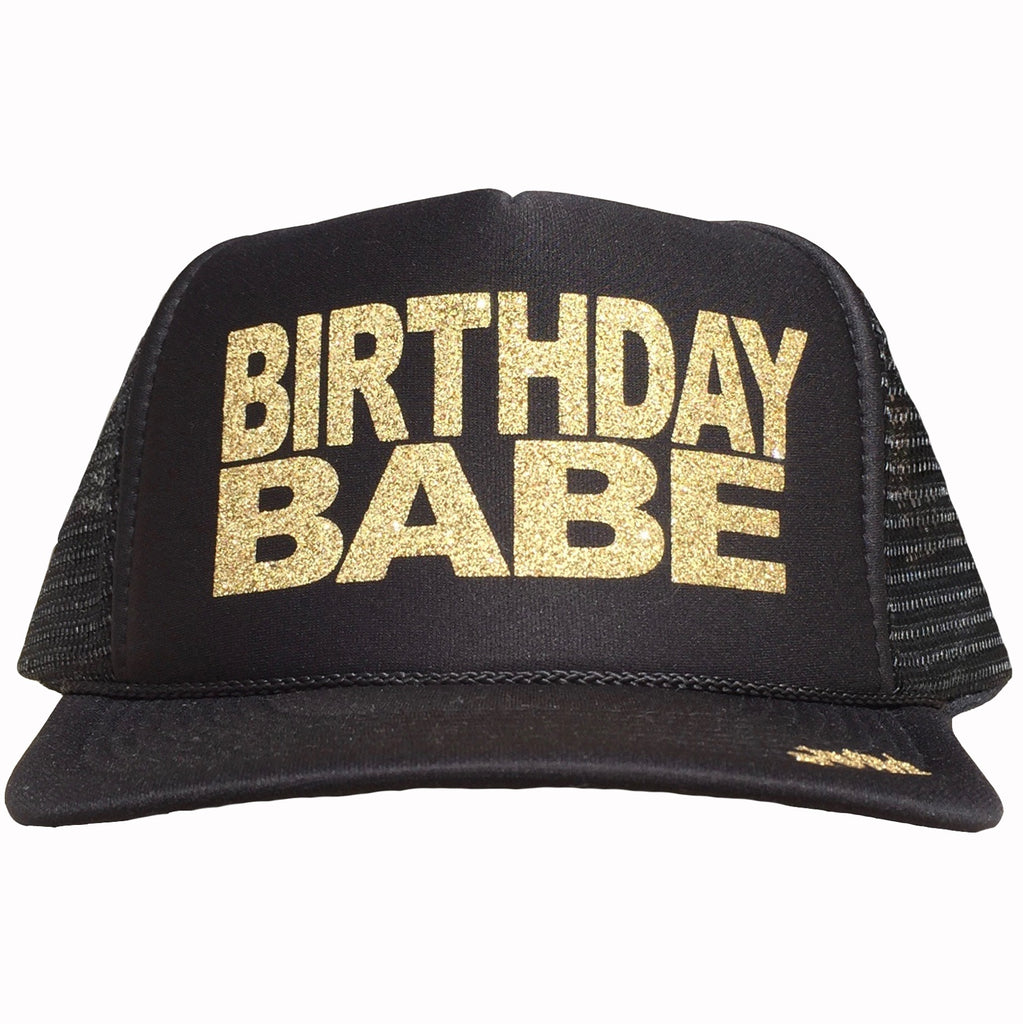 Birthday Babe in glitter gold ink on the front panel of a black trucker cap with an adjustable snapback