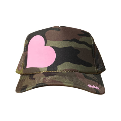 Heart in blush pink ink on the front panel of a classic mesh camo trucker cap with an adjustable snapback