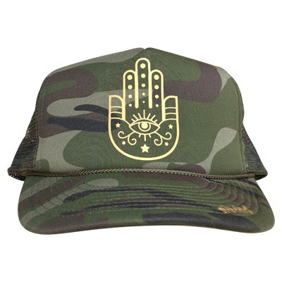 Hamsa Hand graphic in gold ink on the front panel of an olive camo trucker cap with an adjustable snapback