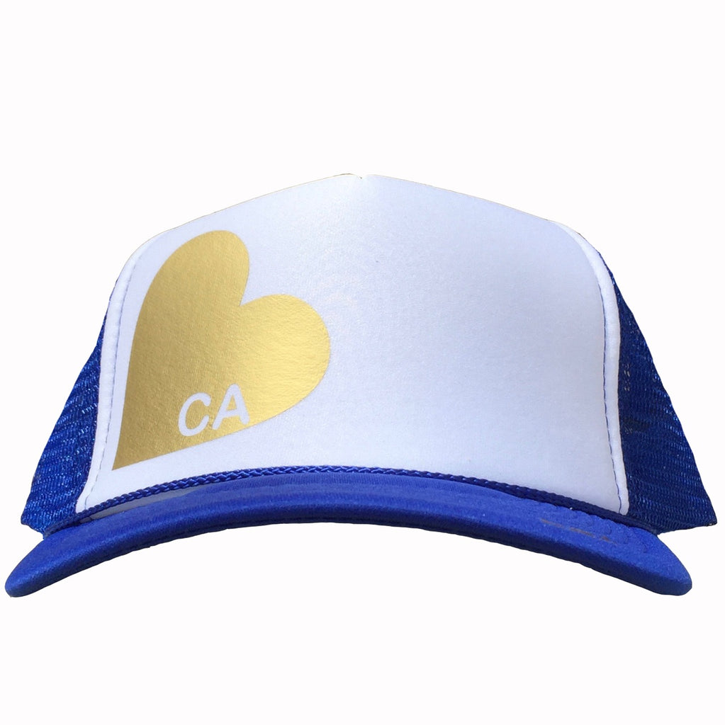 Heart with CA in gold ink on the front panel of a royal-white mesh trucker cap with an adjustable snapback