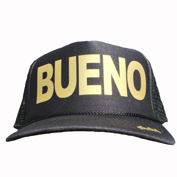 Bueno in gold ink on the front panel of a black mesh trucker cap with an adjustable snapback