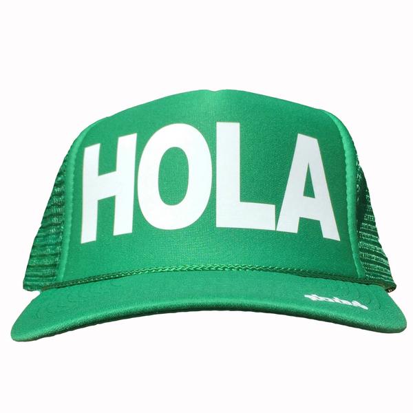 Hola in white ink on the front panel of a green mesh trucker cap with an adjustable snapback