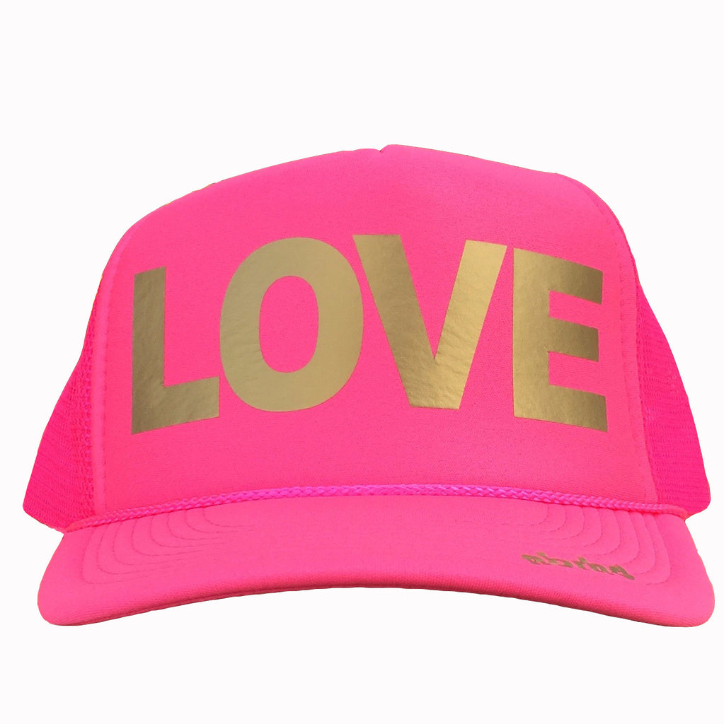 LOVE in gold ink on the front panel of a classic mesh pink trucker cap with an adjustable snapback