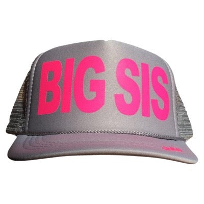 Big Sis in pink ink on the front panel of a kid's mesh light gray trucker cap with an adjustable snapback, small fit