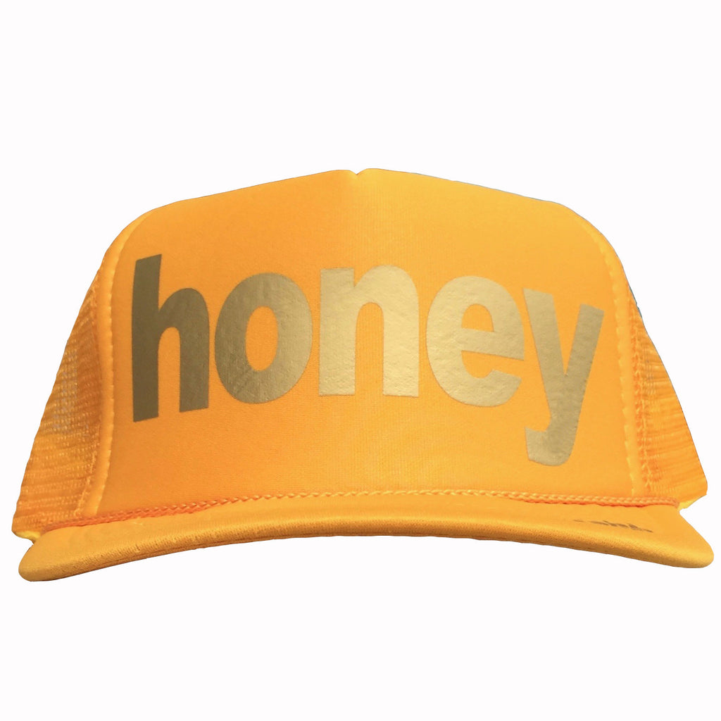 Honey in gold ink on the front panel of a yellow mesh trucker cap with an adjustable snapback