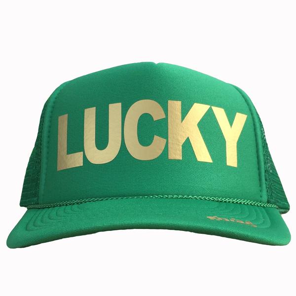 Lucky in gold ink on the front panel of a classic mesh kelly green trucker cap with an adjustable snapback